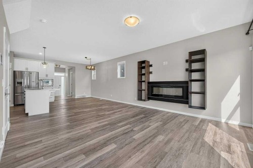 556 Belmont Heath Sw, Calgary, AB - Indoor With Fireplace