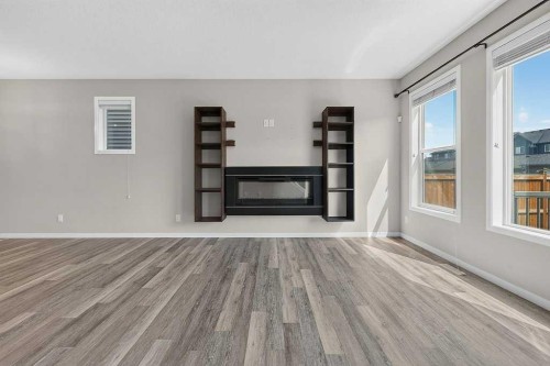 556 Belmont Heath Sw, Calgary, AB - Indoor With Fireplace
