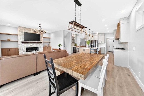 12 Willow Street, Cochrane, AB - Indoor Photo Showing Dining Room With Fireplace