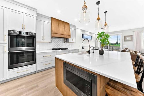 12 Willow Street, Cochrane, AB - Indoor Photo Showing Kitchen With Upgraded Kitchen