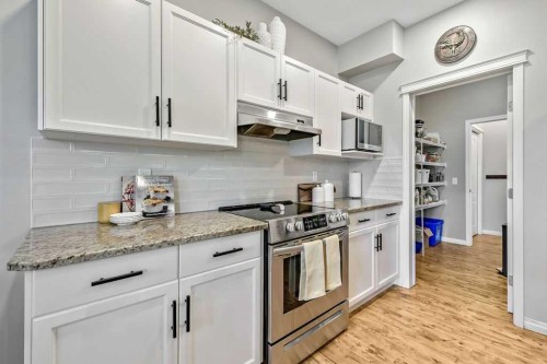 1034 Ranch Road, Okotoks, AB - Indoor Photo Showing Kitchen With Upgraded Kitchen