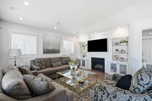 100 Cove Rise, Chestermere, AB - Indoor Photo Showing Living Room With Fireplace