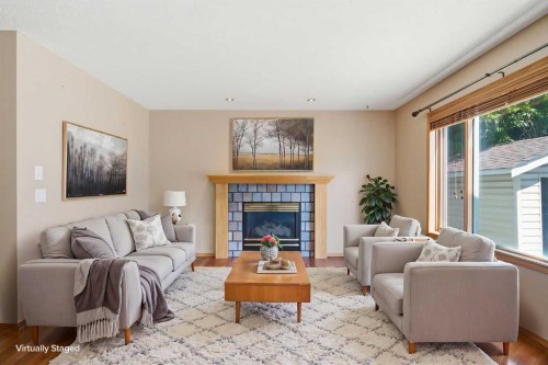 144 Douglas Ridge Close Se, Calgary, AB - Indoor Photo Showing Living Room With Fireplace