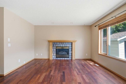 144 Douglas Ridge Close Se, Calgary, AB - Indoor Photo Showing Living Room With Fireplace