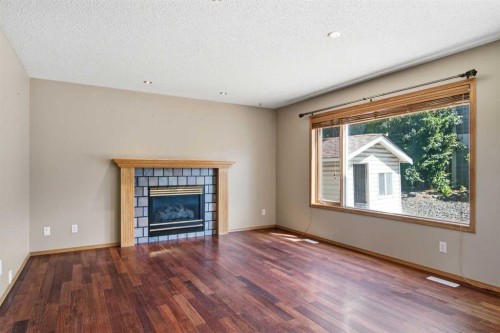 144 Douglas Ridge Close Se, Calgary, AB - Indoor Photo Showing Living Room With Fireplace