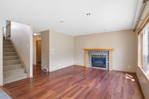 144 Douglas Ridge Close Se, Calgary, AB - Indoor Photo Showing Living Room With Fireplace
