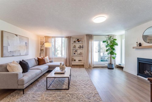 204-3747 42 Street Nw, Calgary, AB - Indoor Photo Showing Living Room With Fireplace