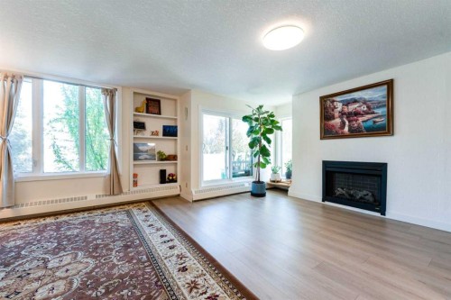 204-3747 42 Street Nw, Calgary, AB - Indoor Photo Showing Living Room With Fireplace