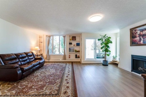 204-3747 42 Street Nw, Calgary, AB - Indoor Photo Showing Living Room With Fireplace