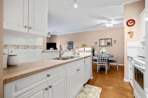 302-15 Lineham Avenue, Okotoks, AB - Indoor Photo Showing Kitchen With Double Sink