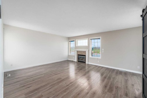 1-12 Silver Creek Boulevard Nw, Airdrie, AB - Indoor Photo Showing Living Room With Fireplace