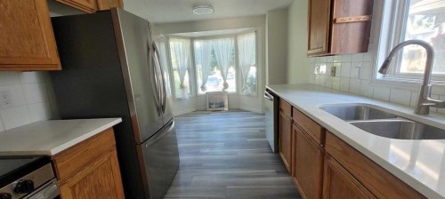 210 Woodmont Court Sw, Calgary, AB - Indoor Photo Showing Kitchen With Double Sink