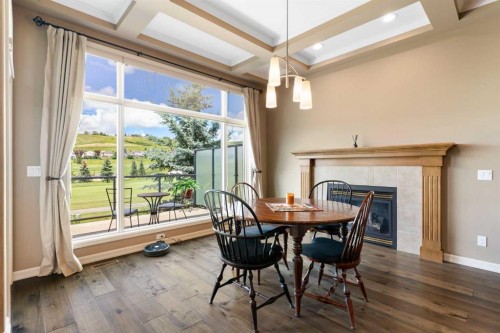 112 Gleneagles View, Cochrane, AB - Indoor Photo Showing Dining Room With Fireplace