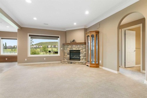 112 Gleneagles View, Cochrane, AB - Indoor Photo Showing Living Room With Fireplace