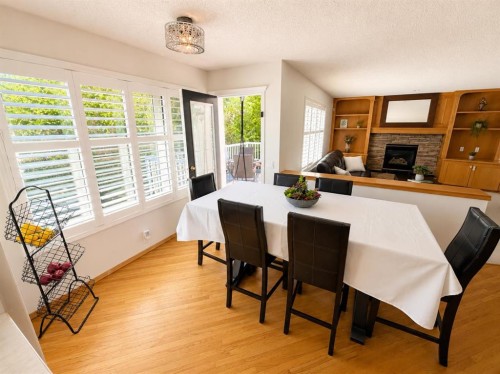 513 Sierra Madre Court Sw, Calgary, AB - Indoor Photo Showing Dining Room With Fireplace