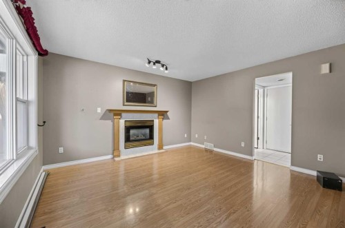 75 Everglade Drive Se, Airdrie, AB - Indoor With Fireplace