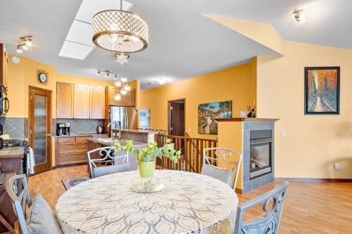 41 Stromsay Gate, Carstairs, AB - Indoor Photo Showing Dining Room With Fireplace