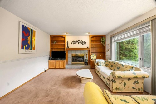 107 Hampshire Close Nw, Calgary, AB - Indoor Photo Showing Other Room With Fireplace