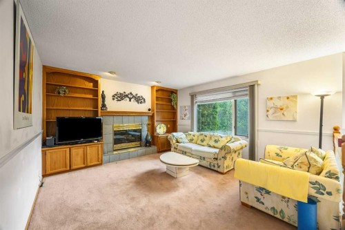 107 Hampshire Close Nw, Calgary, AB - Indoor Photo Showing Living Room With Fireplace