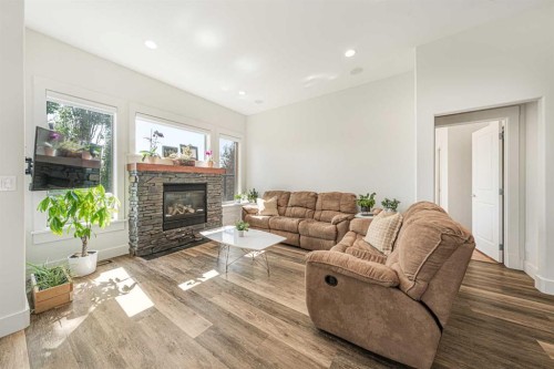 2 Discovery Ridge Heights Sw, Calgary, AB - Indoor Photo Showing Living Room With Fireplace