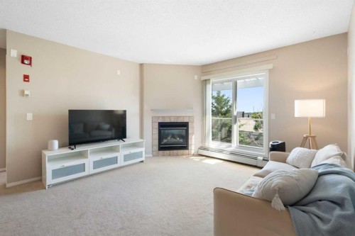 409-290 Shawville Way Se, Calgary, AB - Indoor Photo Showing Living Room With Fireplace