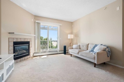 409-290 Shawville Way Se, Calgary, AB - Indoor Photo Showing Living Room With Fireplace