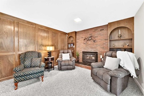 39 Deer Run Place Se, Calgary, AB - Indoor Photo Showing Living Room With Fireplace