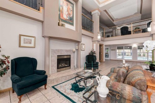 244-8535 Bonaventure Drive Se, Calgary, AB - Indoor Photo Showing Living Room With Fireplace
