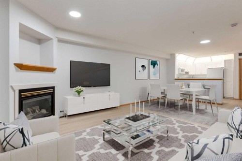 244-8535 Bonaventure Drive Se, Calgary, AB - Indoor Photo Showing Living Room With Fireplace