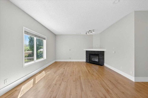 18 Cougarstone Bay Sw, Calgary, AB - Indoor Photo Showing Living Room With Fireplace