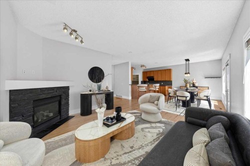 18 Cougarstone Bay Sw, Calgary, AB - Indoor Photo Showing Living Room With Fireplace