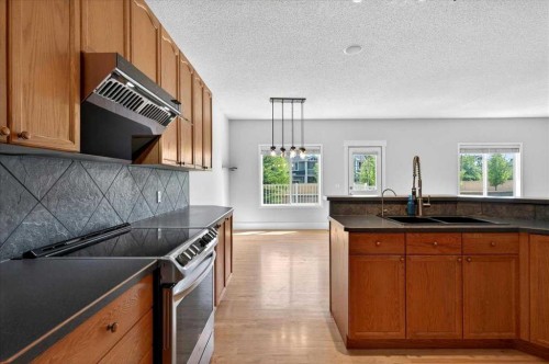 18 Cougarstone Bay Sw, Calgary, AB - Indoor Photo Showing Kitchen With Double Sink