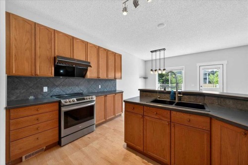 18 Cougarstone Bay Sw, Calgary, AB - Indoor Photo Showing Kitchen With Double Sink