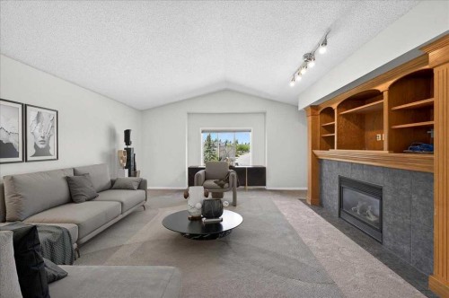 18 Cougarstone Bay Sw, Calgary, AB - Indoor Photo Showing Living Room With Fireplace