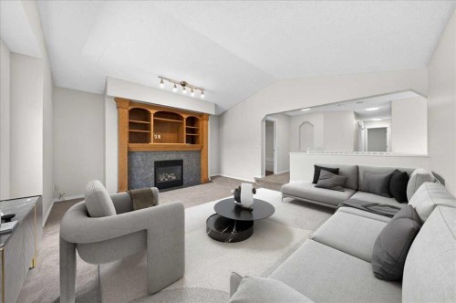 18 Cougarstone Bay Sw, Calgary, AB - Indoor Photo Showing Living Room With Fireplace