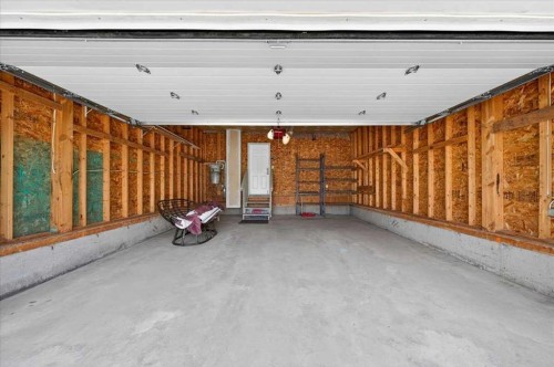18 Cougarstone Bay Sw, Calgary, AB - Indoor Photo Showing Garage
