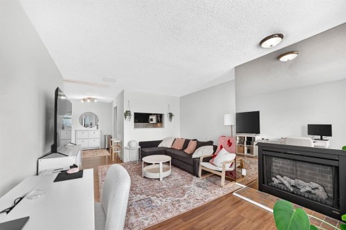 307-3717 42 Street Nw, Calgary, AB - Indoor Photo Showing Living Room With Fireplace