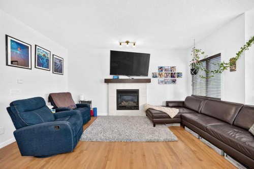 16 Sunrise Crescent, Cochrane, AB - Indoor Photo Showing Living Room With Fireplace