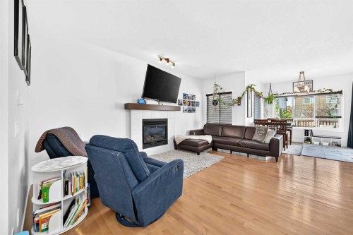 16 Sunrise Crescent, Cochrane, AB - Indoor Photo Showing Living Room With Fireplace