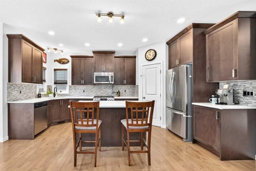 16 Sunrise Crescent, Cochrane, AB - Indoor Photo Showing Kitchen With Upgraded Kitchen