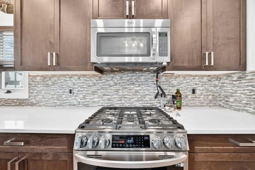 16 Sunrise Crescent, Cochrane, AB - Indoor Photo Showing Kitchen With Upgraded Kitchen