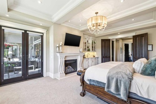 39 Red Willow Crescent West, Rural Foothills County, AB - Indoor Photo Showing Bedroom With Fireplace