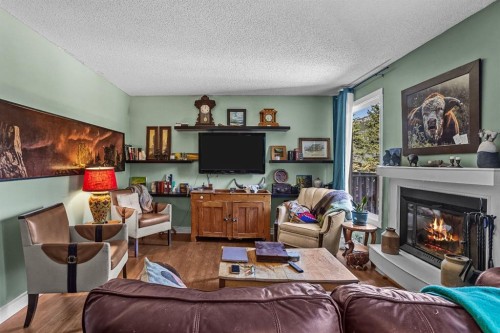 246 Kluane Drive, Banff, AB - Indoor Photo Showing Living Room With Fireplace