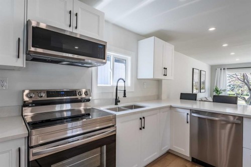 36 Big Hill Way Se, Airdrie, AB - Indoor Photo Showing Kitchen With Stainless Steel Kitchen With Double Sink With Upgraded Kitchen