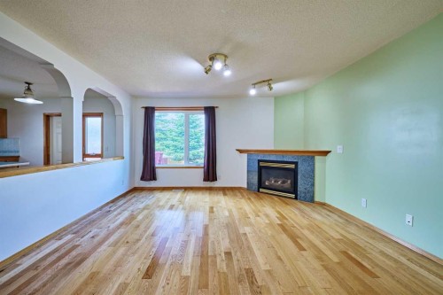 9683 Hidden Valley Drive Nw, Calgary, AB - Indoor Photo Showing Living Room With Fireplace