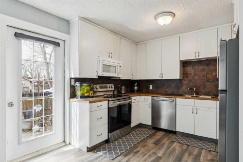 113-107 Elm Place, Okotoks, AB - Indoor Photo Showing Kitchen With Stainless Steel Kitchen