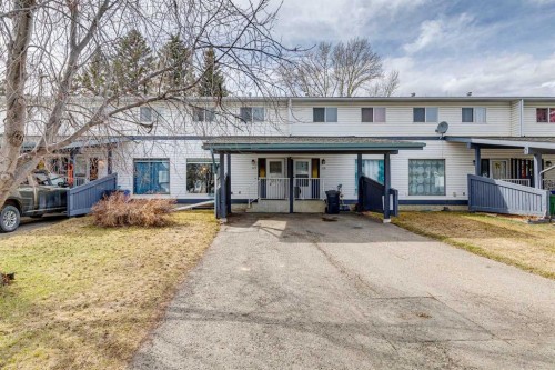 113-107 Elm Place, Okotoks, AB - Outdoor With Facade
