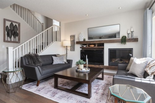 313 Centre Avenue Se, Airdrie, AB - Indoor Photo Showing Living Room With Fireplace