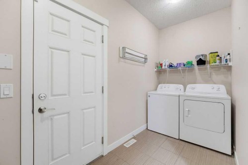 145 Sunset Manor, Cochrane, AB - Indoor Photo Showing Laundry Room