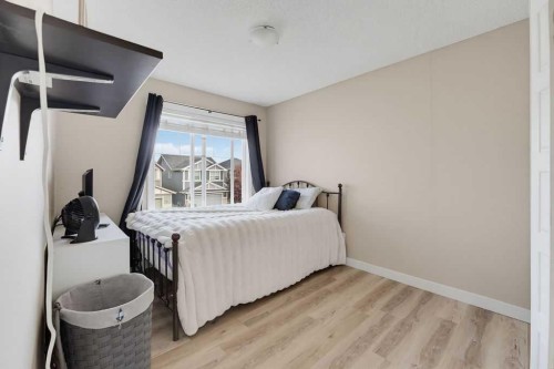 145 Sunset Manor, Cochrane, AB - Indoor Photo Showing Bedroom